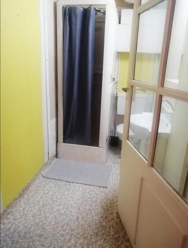 une salle de bain avec une douche avec un rideau de douche bleu dans l'établissement Relais Art Bien-Etre Lumineux Doué en Anjou, à Doué-la-Fontaine