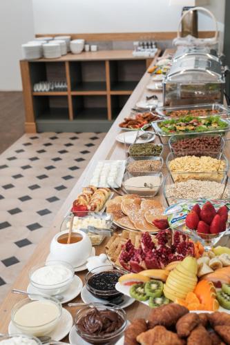 a long table filled with lots of different types of food at GRAND HOTEL GYUMRI by APRICOT Hotels in Gyumri