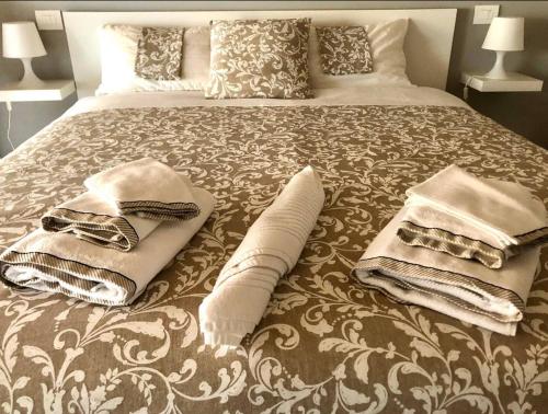 a bed with blankets and pillows on top of it at Mini Alloggi Il Vigneto del Borgo in Due Carrare