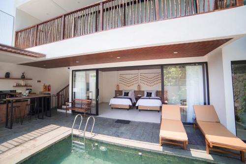 a villa with a pool and a bedroom at Ubu Villa Amarta in Yogyakarta in Ngaglik