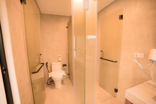 a bathroom with a toilet and a walk in shower at Ubu Villa Amarta in Yogyakarta in Ngaglik