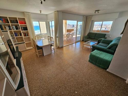 a living room with a green couch and a table at Nautico 16 in Benimagrell