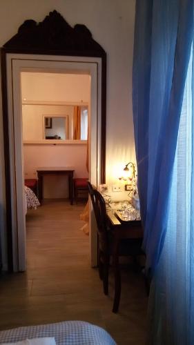 a dining room with a table and a mirror at Villa Fiorita in Monfalcone