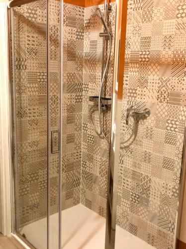 a shower with a glass door in a bathroom at Mini Alloggi Il Vigneto del Borgo in Due Carrare