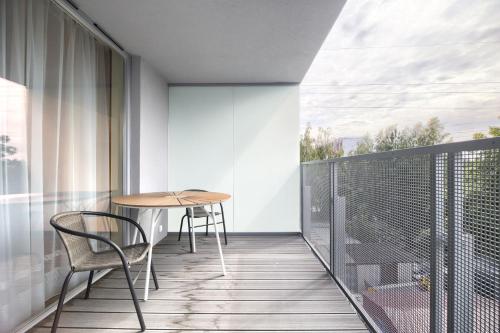 a balcony with a table and chairs on it at AboutArtApartments - Otyńska 4 in Wrocław