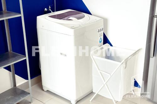 a white washer and dryer in a room at FREE Streaming Services-Designed Studio Home at Cybersquare, Cyberjaya by Flexihome-MY in Cyberjaya