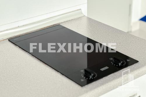 a sign on a counter with the word flexium at FREE Streaming Services-Designed Studio Home at Cybersquare, Cyberjaya by Flexihome-MY in Cyberjaya