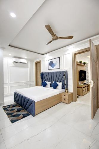 a bedroom with a bed and a ceiling fan at Miyabi suites in Gurgaon
