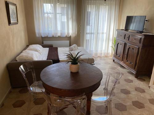 a living room with a table and a bed at Cascina Bricco San Pietro Bed & Wine in Monforte dʼAlba