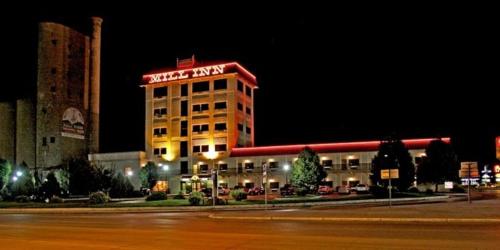 a building with a sign on top of it at night at Mill Inn in Sheridan