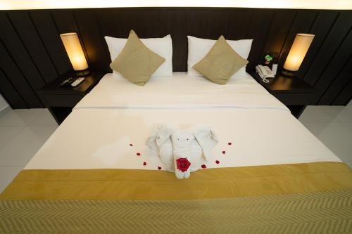 a bed with an elephant made out of red flowers at Good wood Airport Hotel in Katunayake