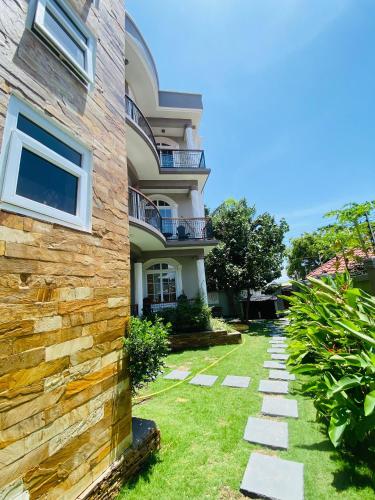 a house with a stone pathway in front of it at Jacomo Residences in Dar es Salaam