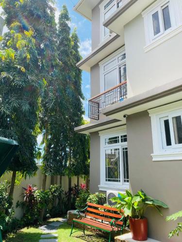 a wooden bench in front of a house at Jacomo Residences in Dar es Salaam