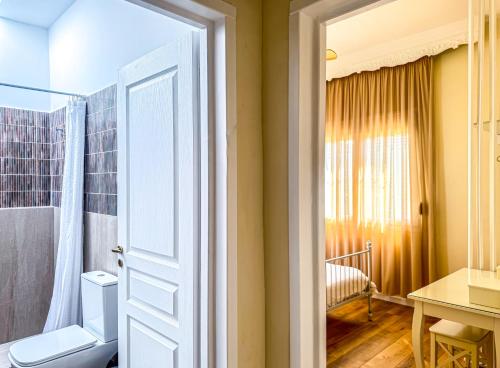 a bathroom with a toilet and a shower at Cityscape Residence with a Patio in Volos
