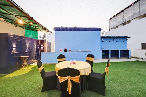 a stage with a table and chairs on the grass at Hotel 91 Golf Course Road in Gurgaon