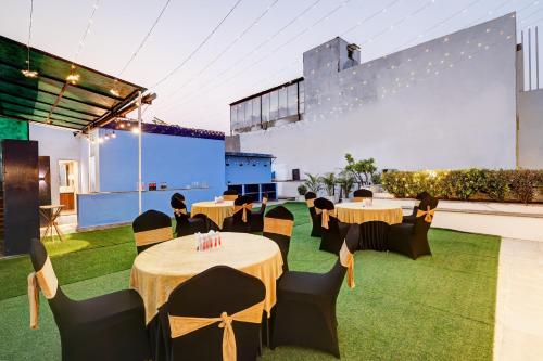 a banquet hall with tables and chairs on grass at Hotel 91 Golf Course Road in Gurgaon