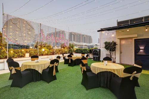 a banquet hall with tables and chairs on grass at Hotel 91 Golf Course Road in Gurgaon