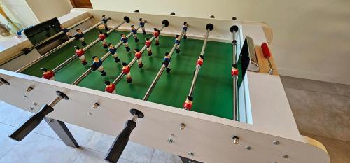 a pool table with a group of people on it at Chambre d'hôte de charme L'Escapada Les Échappées Belles in Antignac