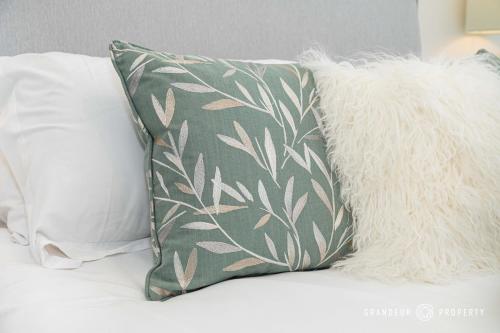 a pillow sitting on top of a bed at Seaview Retreat by Grandeur Property in Southbourne