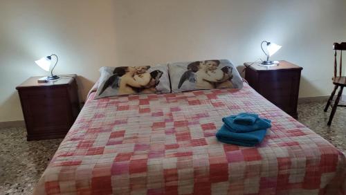 a bed with a blanket with three naked men on it at Casa di Angela in Siracusa