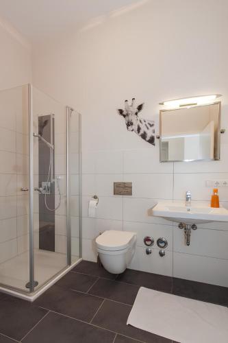 a bathroom with a shower and a toilet and a sink at Wohnen am Kulturspeicher mit eigenem Parkplatz in Würzburg
