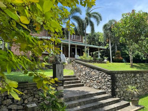 a house with stairs and a stone wall at Airport Green Olive Villa in Katunayaka