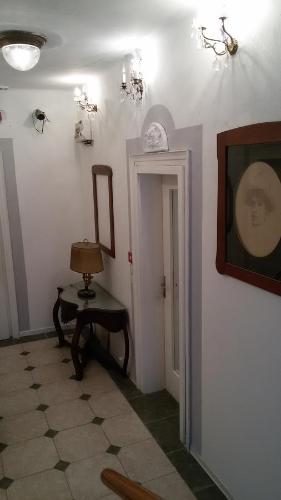 a hallway with a table and a mirror on the wall at Villa Fiorita in Monfalcone