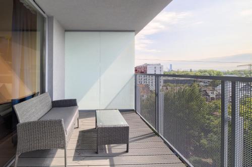 a balcony with two chairs and a table at AboutArtApartments - Otyńska 4 in Wrocław