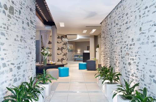 a hallway with plants and a brick wall at Sofitel Queenstown Hotel & Spa in Queenstown