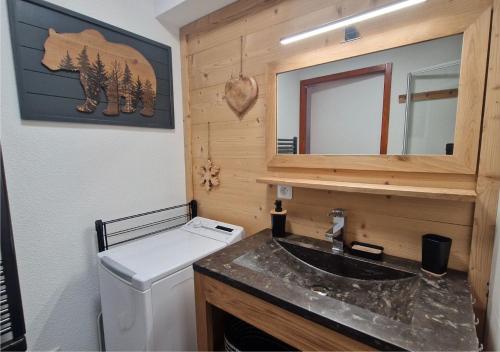 a bathroom with a white toilet and a sink at Le Flocon de Thollon in Thollon