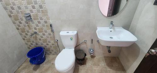a bathroom with a white toilet and a sink at SD Zanita Heights Sea Facing Serviced Apartments in Vasco Da Gama