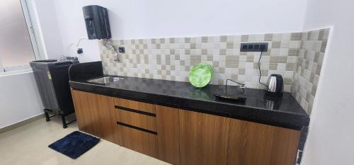 a kitchen counter with a sink and a phone at SD Zanita Heights Sea Facing Serviced Apartments in Vasco Da Gama