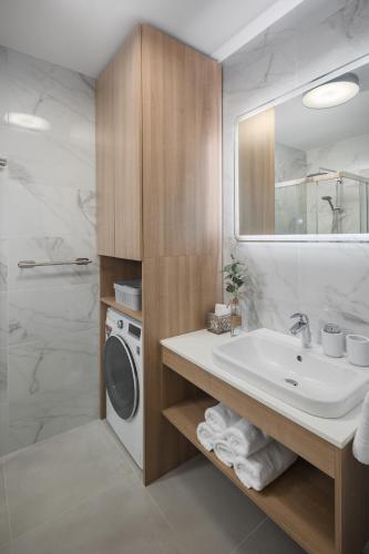 a bathroom with a sink and a washing machine at Apartment Corsy in Novigrad Istria
