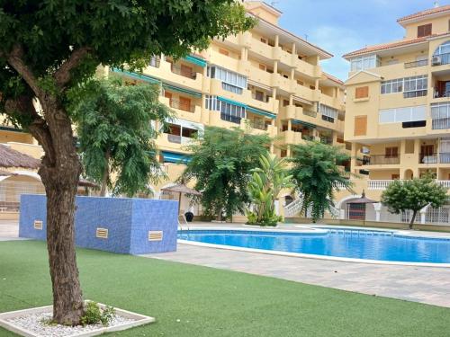 a swimming pool in front of a apartment building at ESTUDIO Torrevieja P & A in La Mata