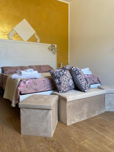 a room with a bed and a couch with pillows at MareSol in Marsala