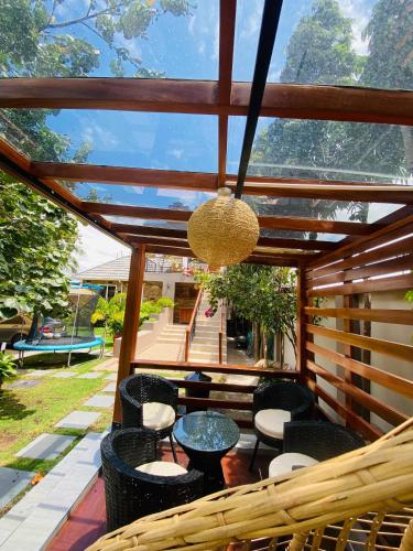 a patio with a table and chairs on a porch at Jacomo Residences in Dar es Salaam