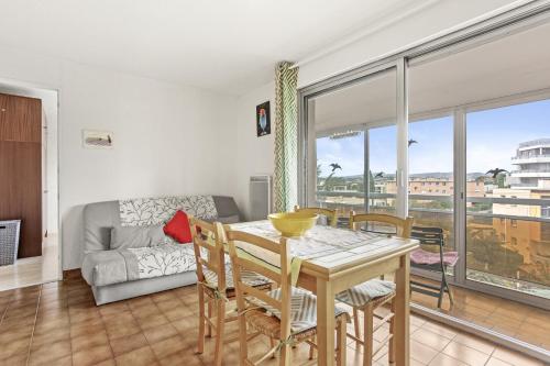 un salon avec une table, des chaises et un canapé dans l'établissement Appart au coeur de Saint-Raphael, à Saint-Raphaël