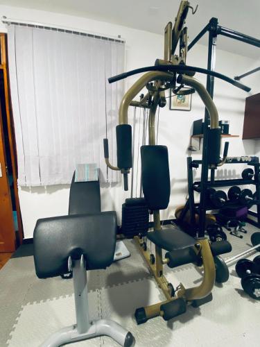 a gym with several exercise equipment in a room at Jacomo Residences in Dar es Salaam