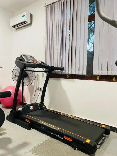 a treadmill in a room with a window at Jacomo Residences in Dar es Salaam