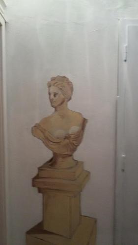 a statue of a woman sitting on a wall at Villa Fiorita in Monfalcone