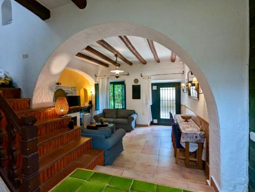 a living room with an archway in a house at Casa dentro del castillo de Tossa de Mar in Tossa de Mar