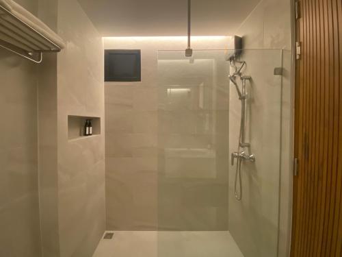 a shower with a glass door in a bathroom at The Celestrail - Check-In by Appointment Only Non-Hotel Private Apartment Onnut BTS in Amphoe Phra Khanong