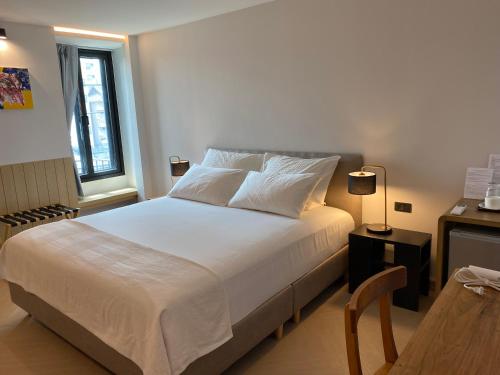 a bedroom with a large white bed and a table at The Celestrail - Check-In by Appointment Only Non-Hotel Private Apartment Onnut BTS in Amphoe Phra Khanong