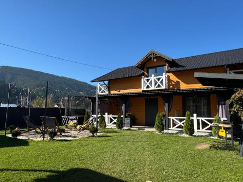 a house with a yard in front of it at Weekend house in Verkhovyna