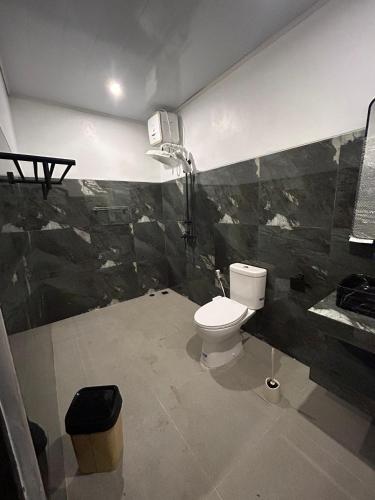 a bathroom with a toilet and a shower at Palacio Balangan Villa in Uluwatu