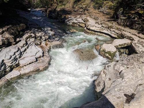 a river with white water and rocks on a mountain at Privatzimmer und Küche mit Balkon und Ausblick in Golling an der Salzach