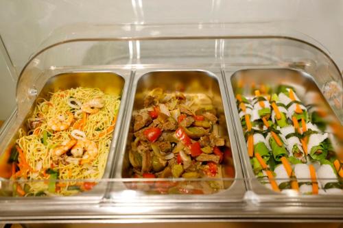 a plastic container filled with different types of food at 사이공 트래블 라운지 Saigon Travel Lounge in Ho Chi Minh City