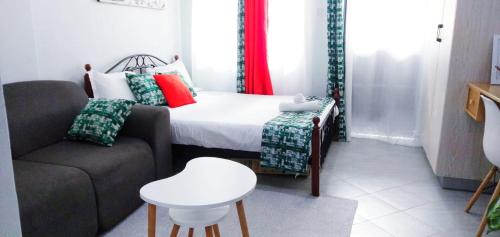 a small room with a couch and a bed at VIVI GRAY ,Muthiga, Waiyaki Way in Nairobi
