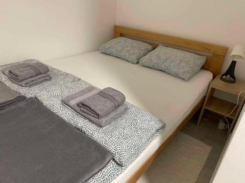 a bedroom with two twin beds with towels on them at Apartman Djokic 3 in Požarevac