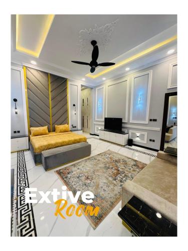 a living room with a couch and a ceiling fan at Emerald Villa Swat by Khan Familia Travels in Swat